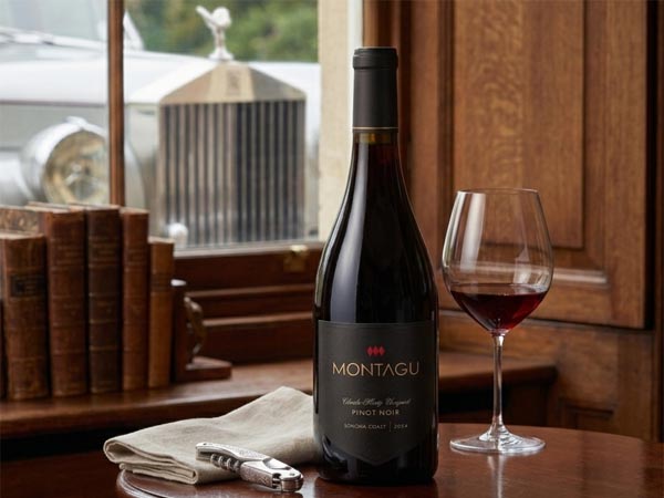 2024 Montagu Charles Heintz Vineyard Pinot Noir bottle with a Riedel wine glass and vintage Rolls-Royce in a luxury library setting